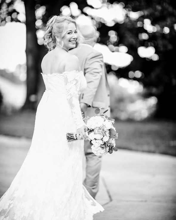 bride and groom holding hands
