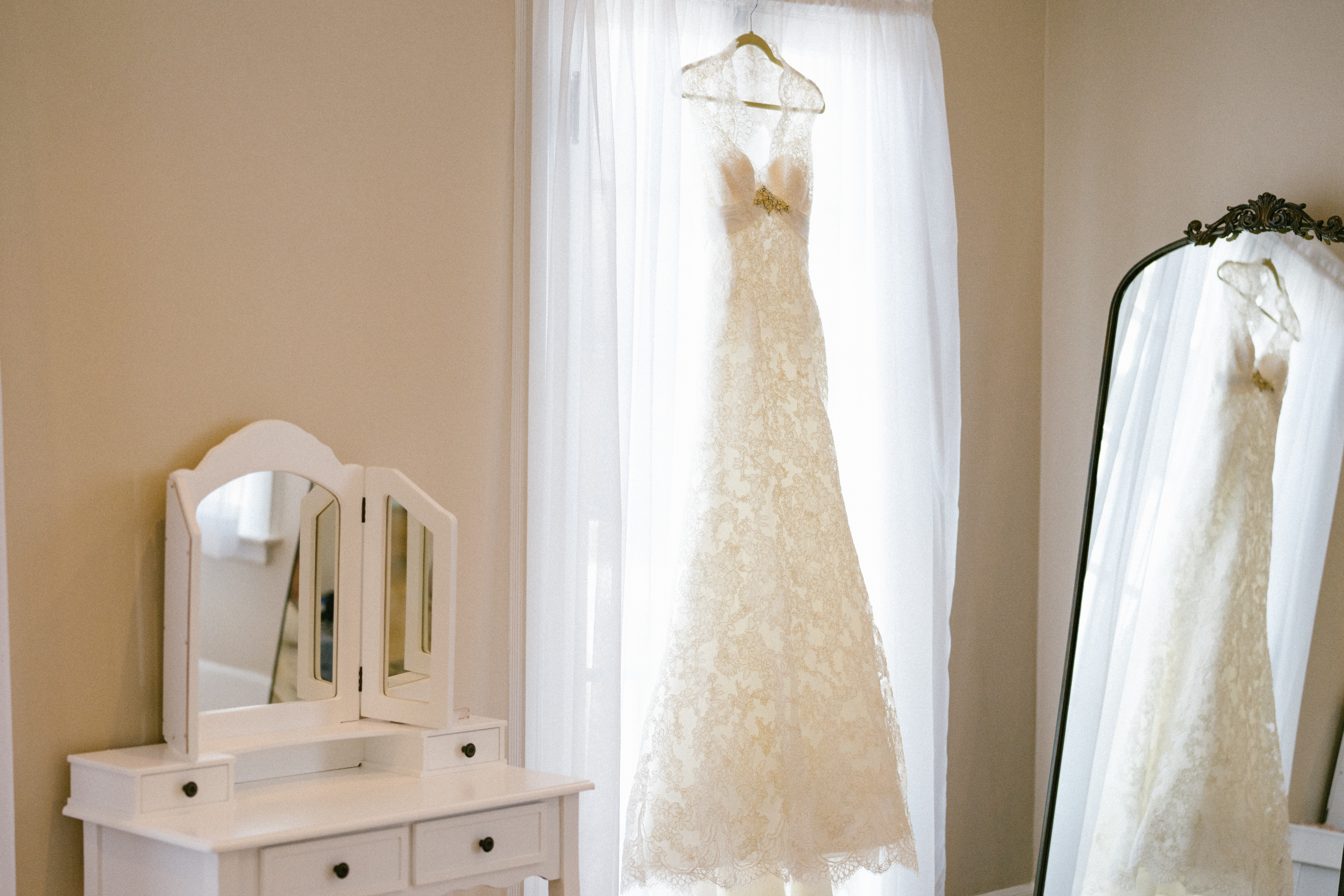 wedding gown hanging in window