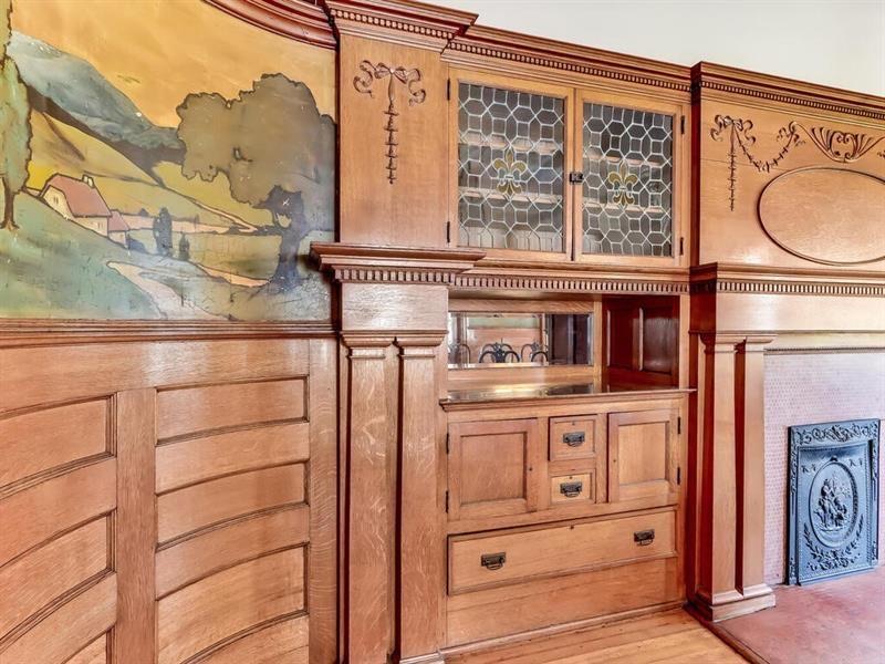 built in bar and wood paneling in dining room