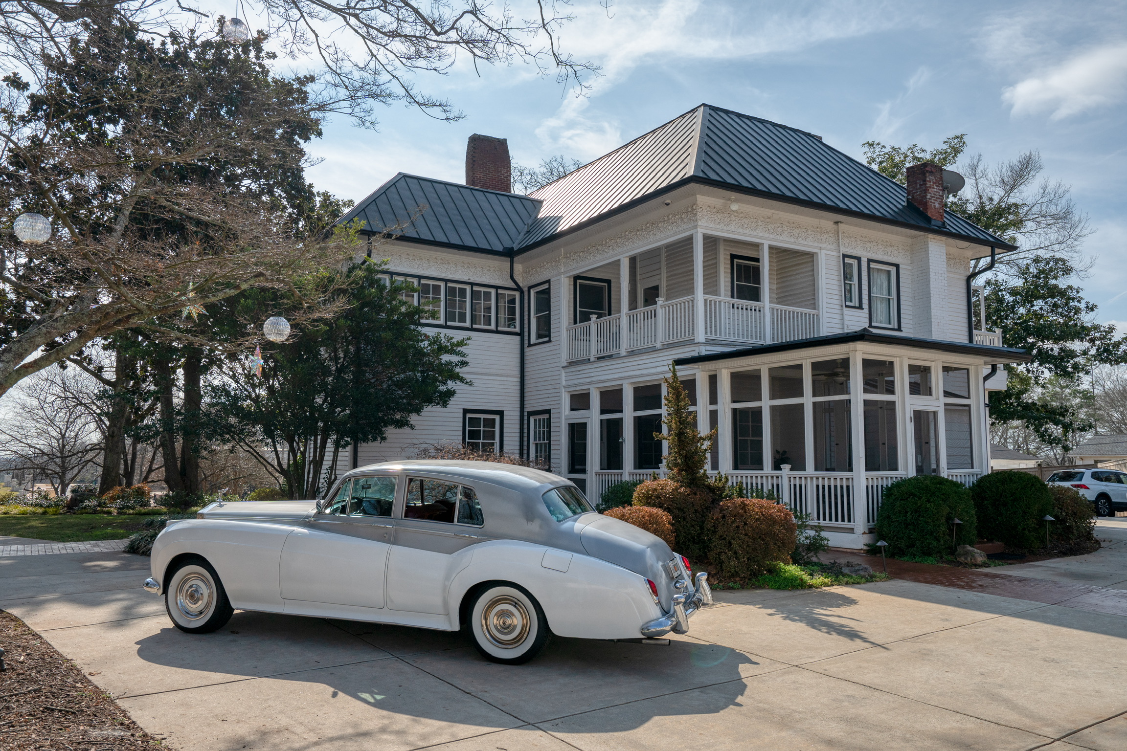 white antique car in front of stonehedge estate
