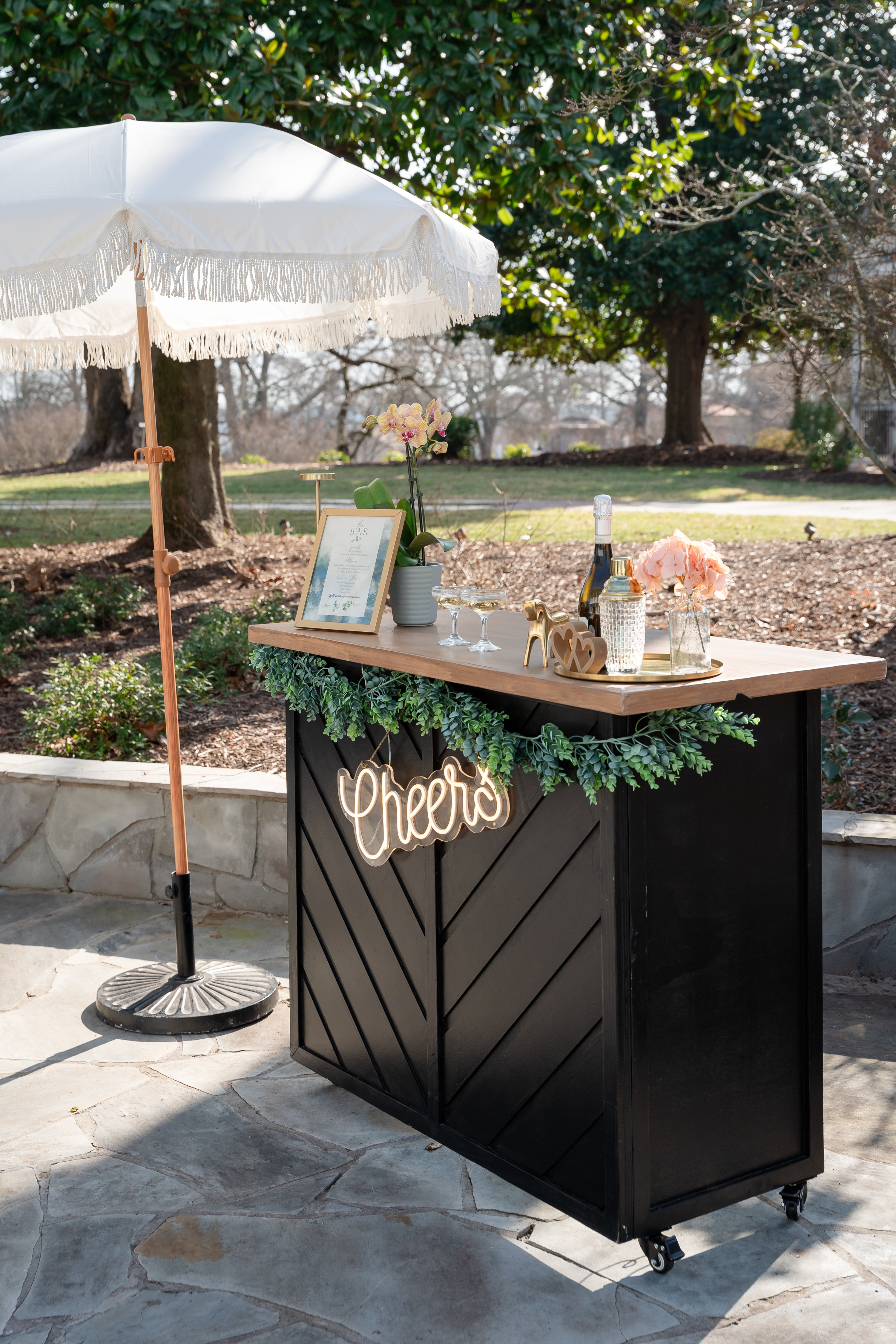 bar cart and tassel umbrella at wedding