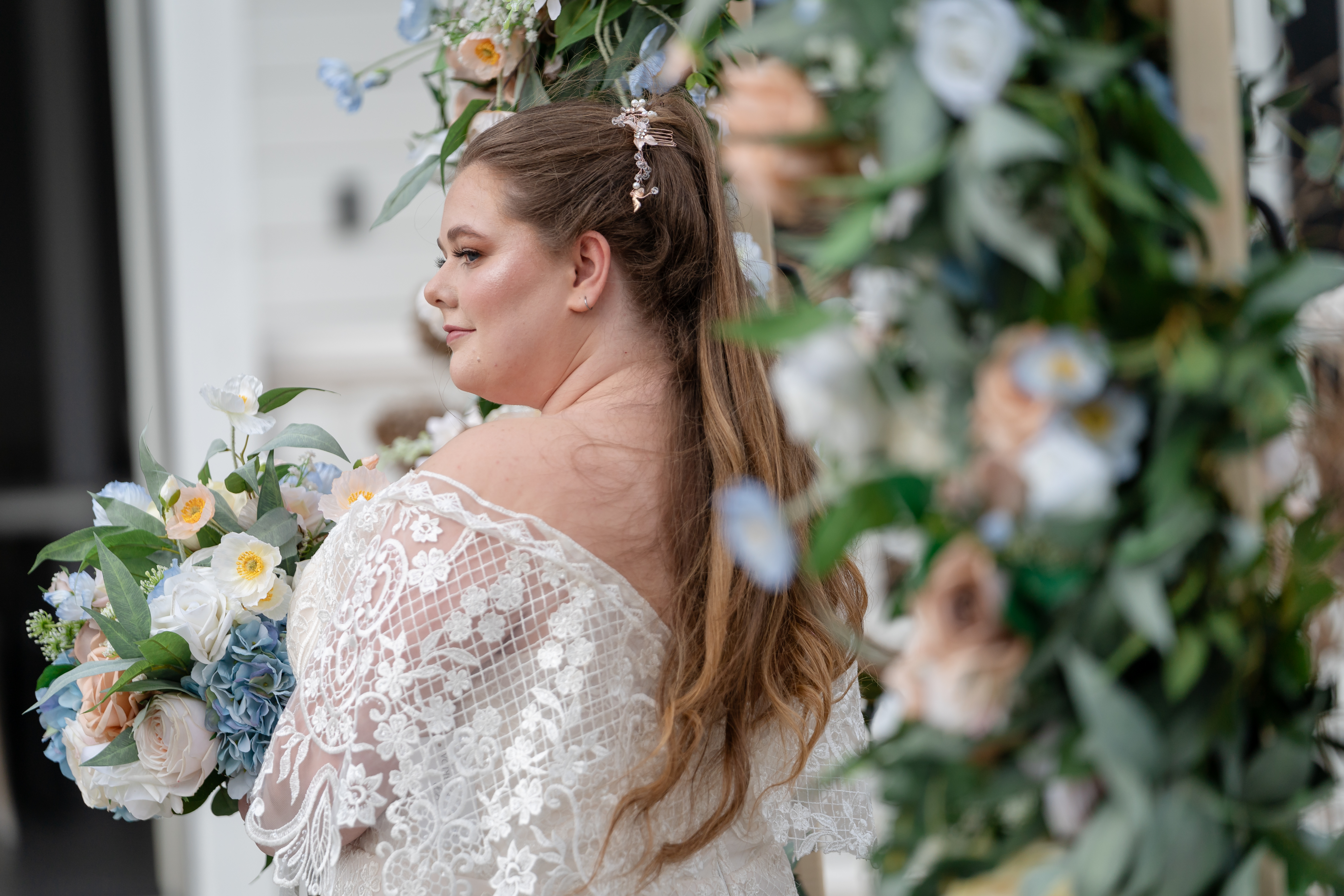 bride holding blue and white bridal bouquet
