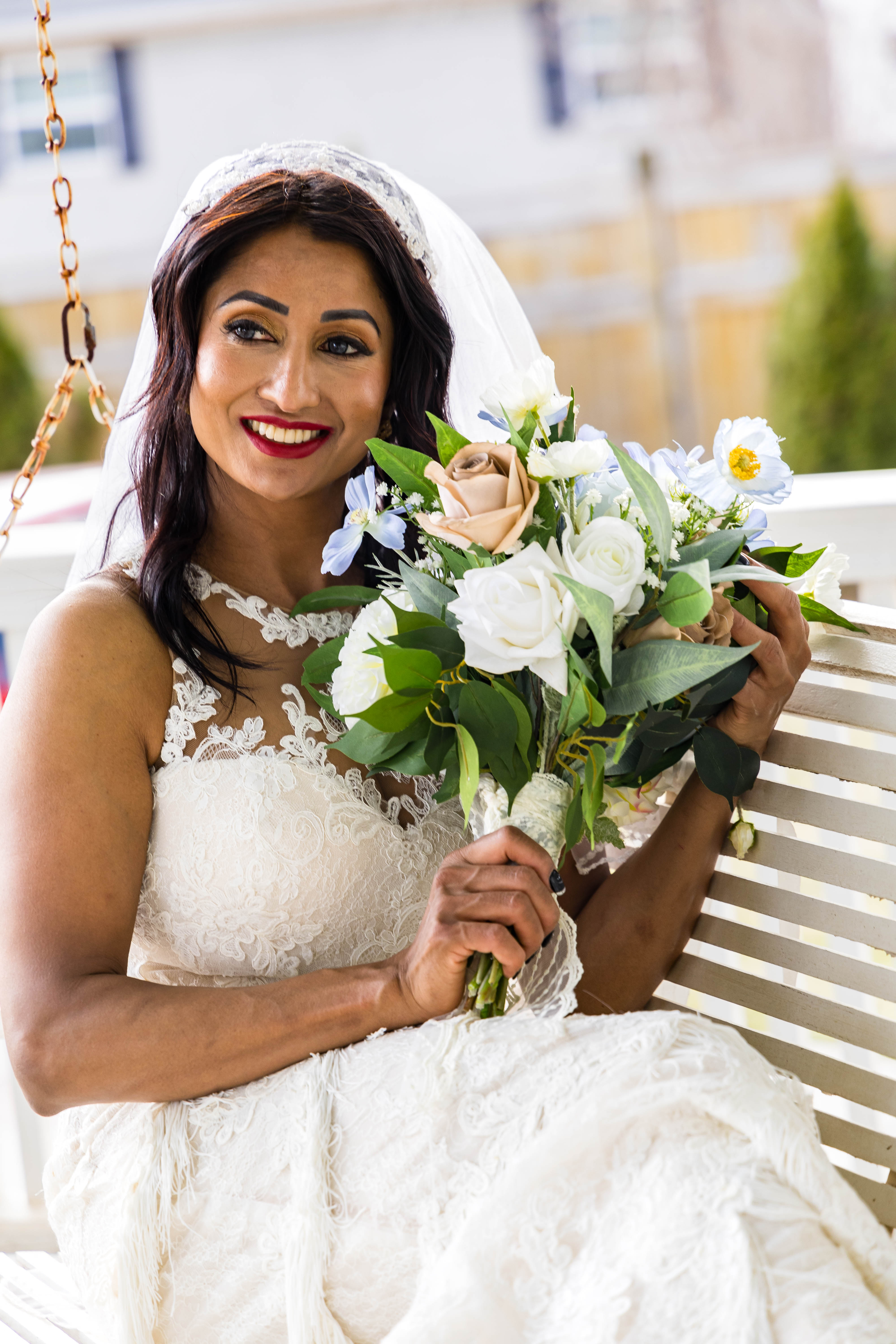 bride sitting on stonehedge estate porch swing