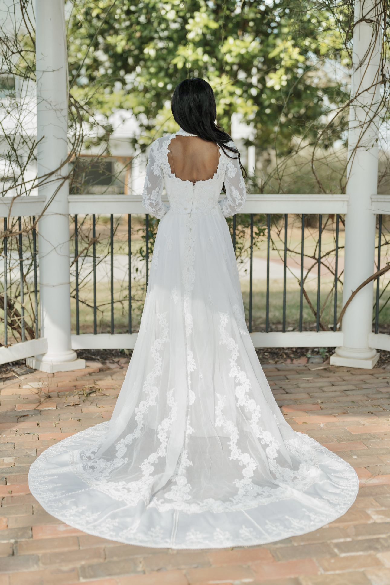 bride standing under pavilion